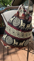 Drawstring backpack-style bag, handwoven in native Andean style with llama motifs.