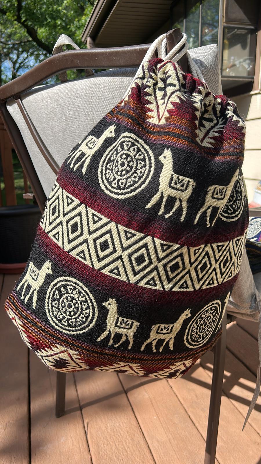 Drawstring backpack-style bag, handwoven in native Andean style with llama motifs.