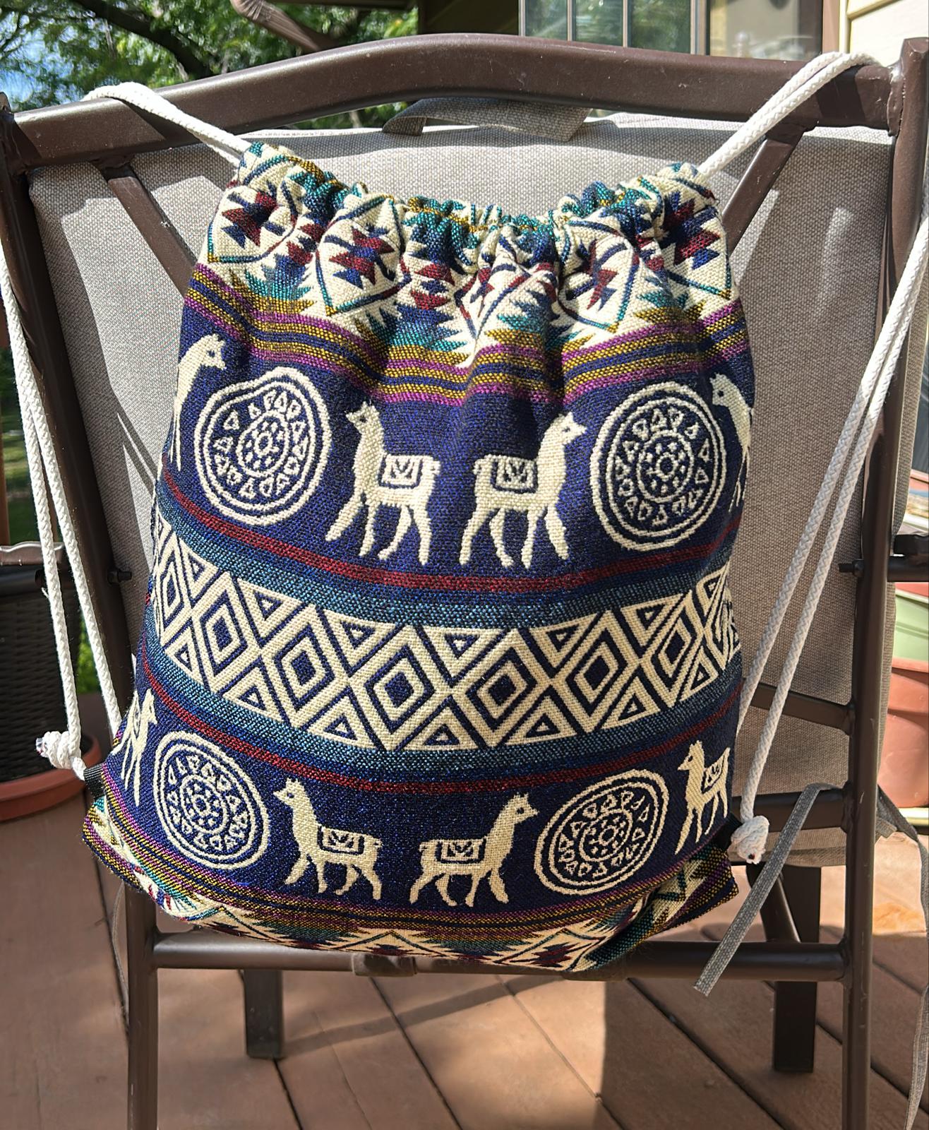 Drawstring backpack-style bag, handwoven in native Andean style with llama motifs.